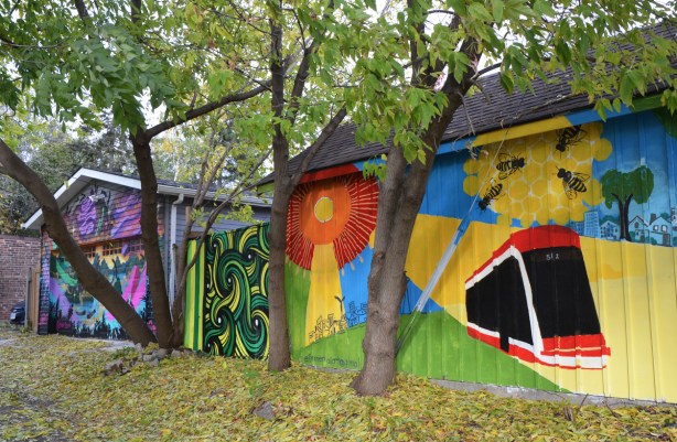 behind trees, in the autumn, murals on the sides of garages, TTC streetcar, orange flower, green abstract, 