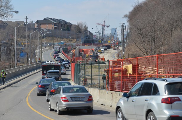 traffic drives west along Eglinton Ave., up the hill from Leslie, through the crosstown LRT construction 