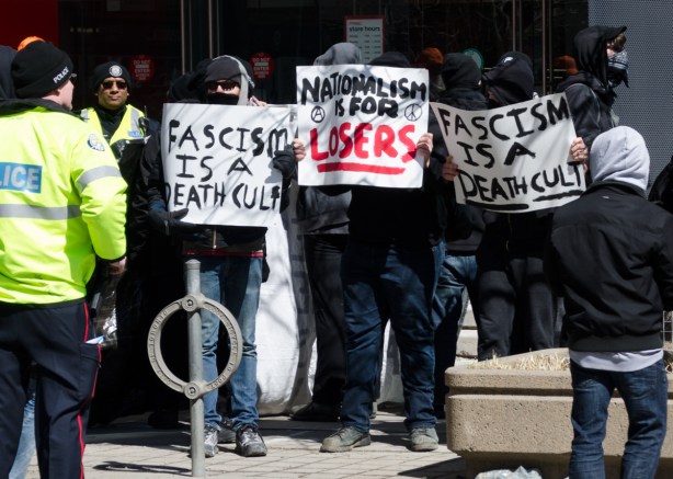 three signs at a protest 