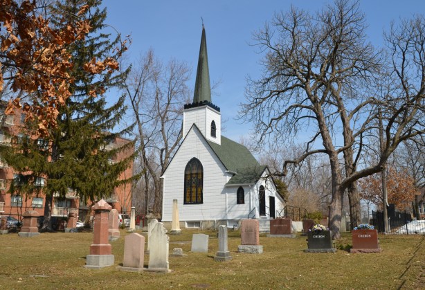 a small white church in a cemetery, St. Juds Anglican church built in 1848 