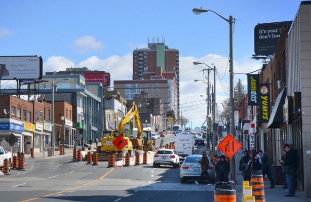 street scene, traffic and stores, construction in the middle of the street, Eglinton Avenue looking wast from Keele street