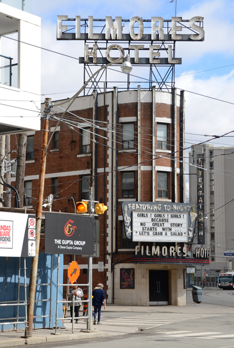 Filmores Hotel with large sign above the hotel and a black and white sign over the front entrance, old brick building