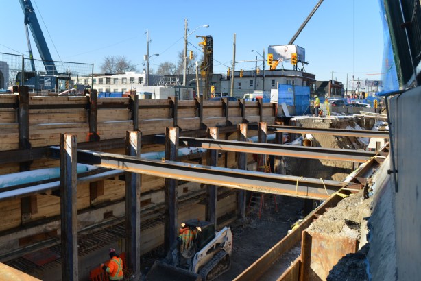 open pit excavation of underground LRT, steel cross beams and wood supports, 