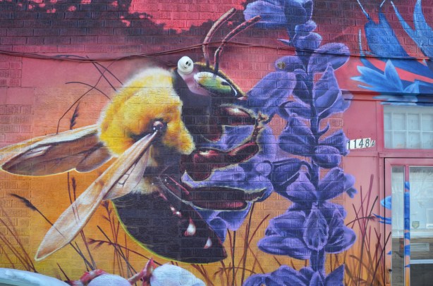 part of a nick sweetman pollinators mural, a bee on a purple flower