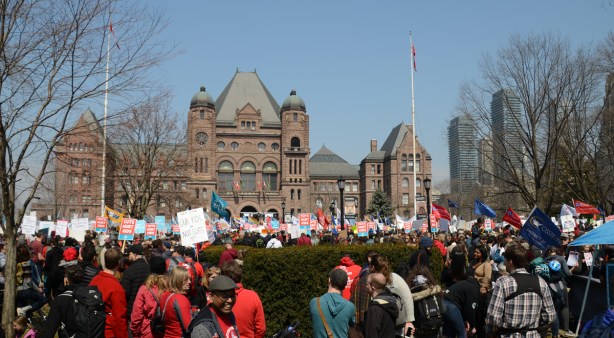 Crowds at a protest at Queens Park, 