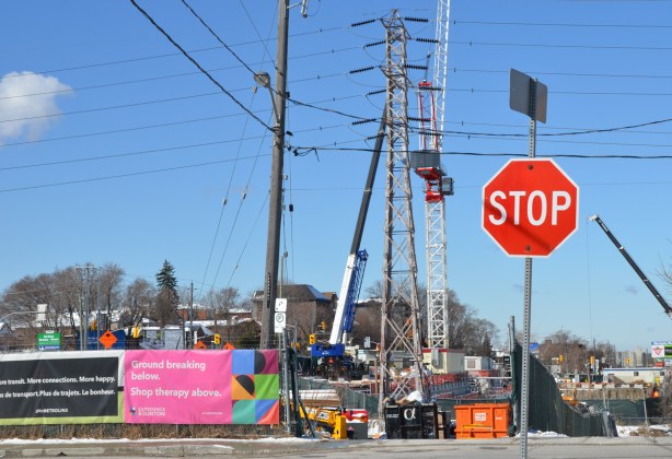 stop sign in front of a construction site on Eglinton Ave