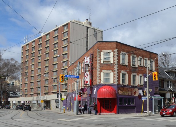the True Love Cafe on the corner of Dundas and Sherbourne, purple walls on exterior ground floor, large red awning over entrance, 