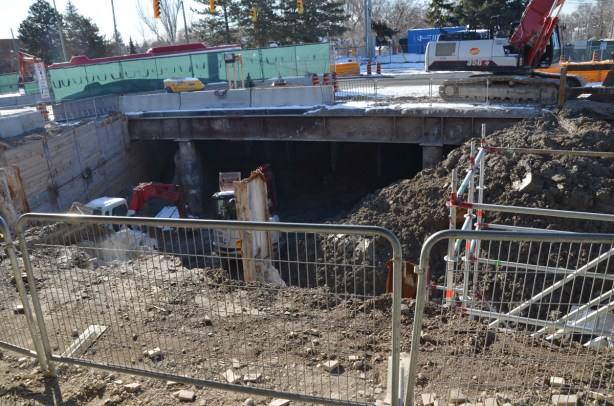 construction site, excavation and building under a road