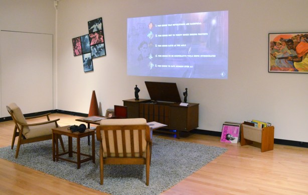 living room furniture arrangement as part of a gallery exhibit, heave, by carrie Mae Weems