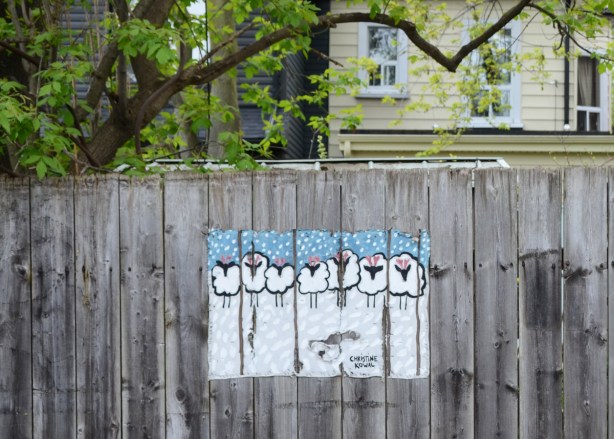 picture of sheep on a wood fence