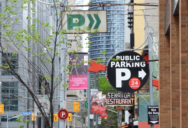 signs, senator restaurant, public parking, and an old green _ parking sign 