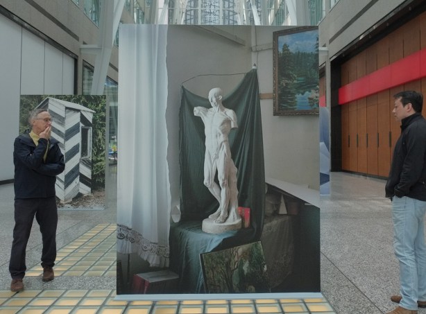 large picture of an old white statue, Brookfield Place, 2 men looking at it. Photo's title is A sculptural model in a student atelier, Spitak Armenia