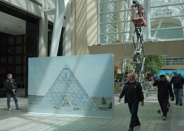 people walking past a large photo in Allan Lambert Galleria at Brookfield Place. Photo by Sputnik Photos, title is Cafeteria at the Heydar Aliev Centre, Gobustan Azerbijan, 