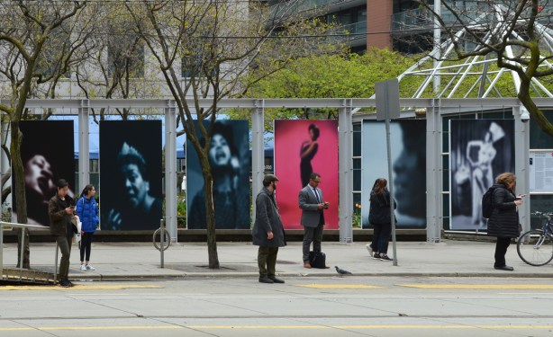 series of large panel photos by Carrie Mae Weems, Slow Fade to Black, each photo is a person or a face that is blurry, done with one colour on black 