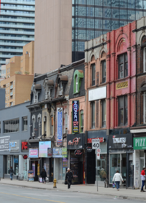 a variety of ages of buildings on Yonge street from those built in the 1800s to modern glass buildings. 