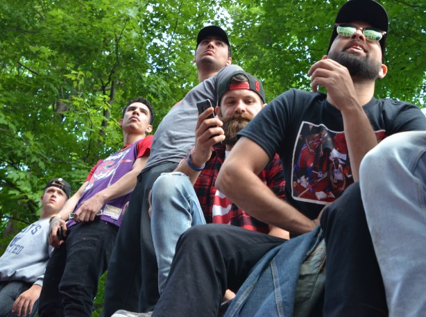Raptors championship parade day, , young men sitting on the fence in front of Osgoode Hall 