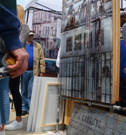 at an art show, an art piece made of metal, images on metal