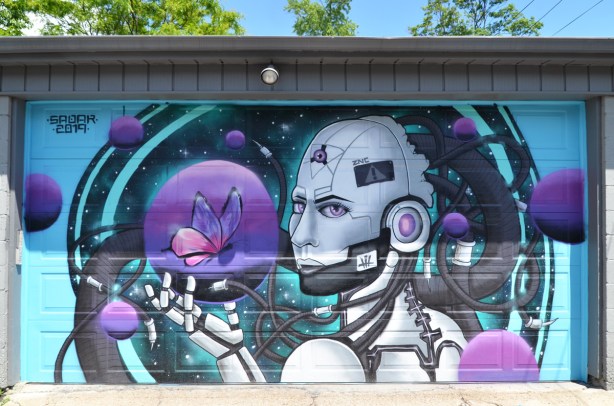 painted mural on a garage door in a lane, butterfly,