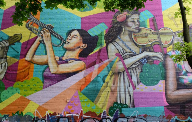 part of a mural, two women musicians, a trumpet player and a violin player