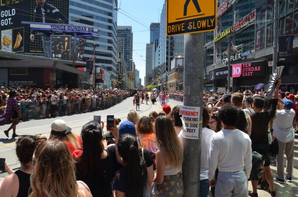 many people line both sides of Dundas as the first group of walkers comes through at the pride parade, indigenous people, drummers, dancers, 