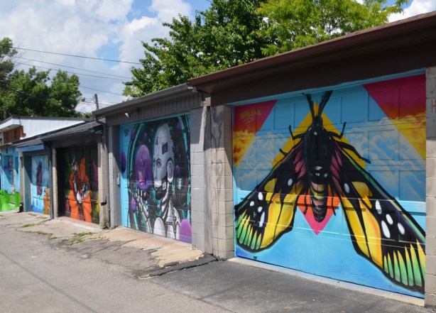butterfly murals painted on garage doors in an alley