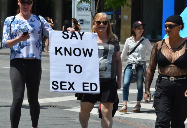 people at dyke march with large sign that says Say know to sex ed
