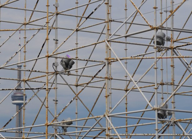 scaffolding holds lights for a show at Ontario Place, in the distance is the CN Tower. 