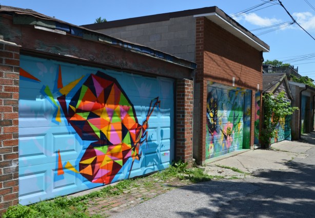 two butterfly murals in an alley