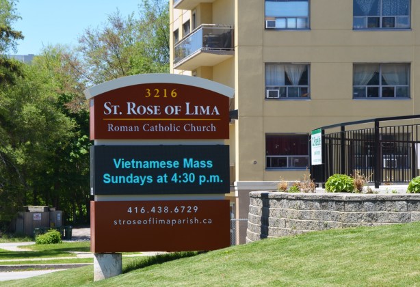 signoutside St. Rose de Lima Roman Catholic Church advertising Vietnamese Mass on Sunday afternoons 