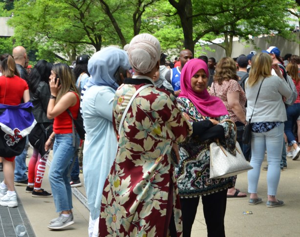 Raptors fans, parade day, muslim women in head scarves and one woman in long flowery dress