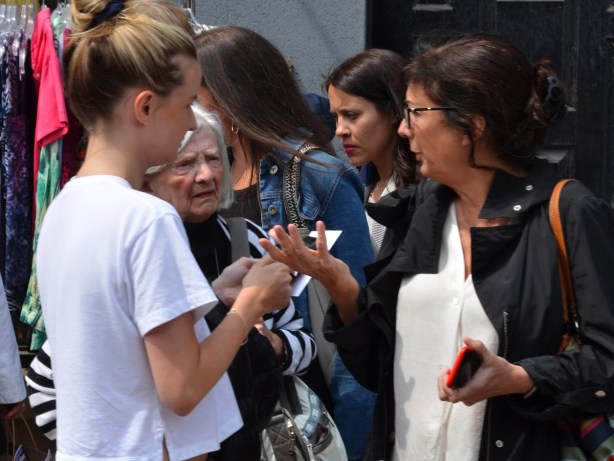 a group of women talking, outside