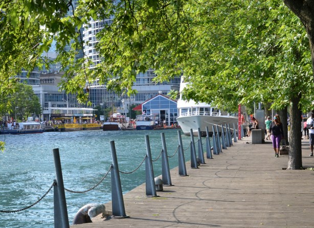 waterfront beside Harbour Square Park, walkway, trees, and boats 