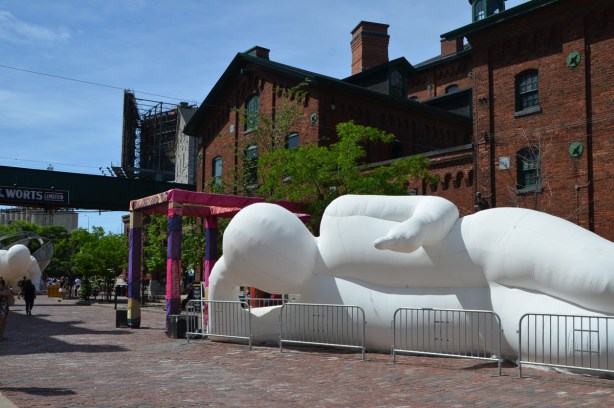 large white inflatable alien creature, lying down