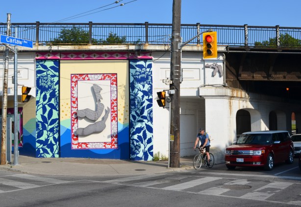part of a railway overpass has been painted with street art