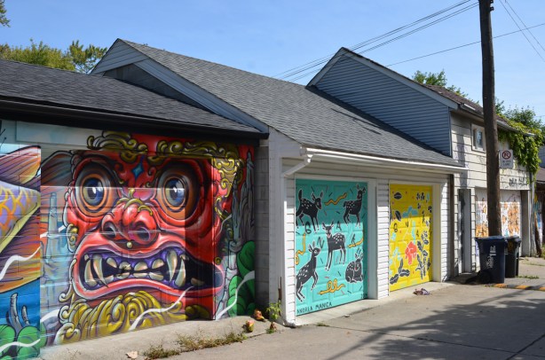 garage doors with murals on Croft Street including one by Bruno Smokey
