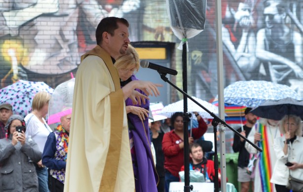 two Christian religious leaders talk at a rally 