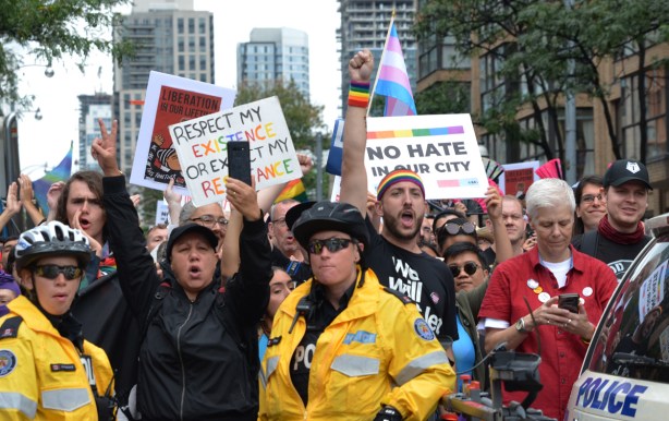 pro-pride counter protesters behind a police line 