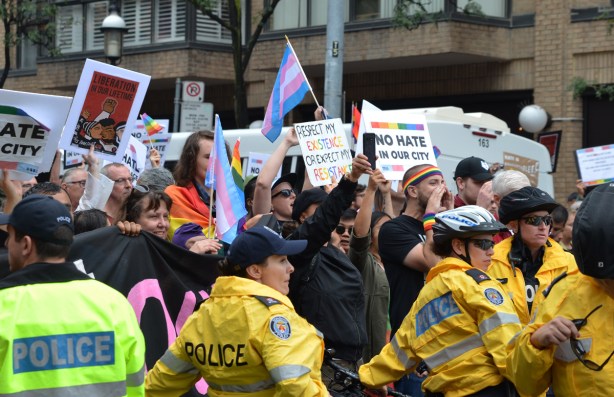 pro-pride counter protesters behind a police line 