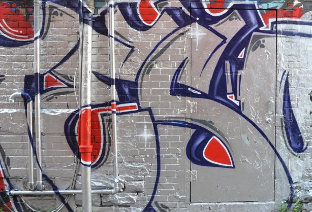 large text street art in silver with blue and red highlights 