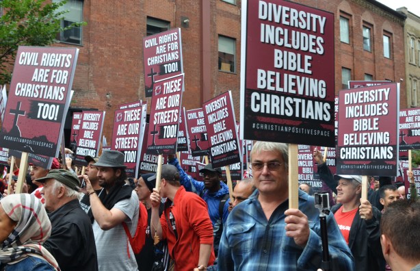 people with signs and placards at a protest 