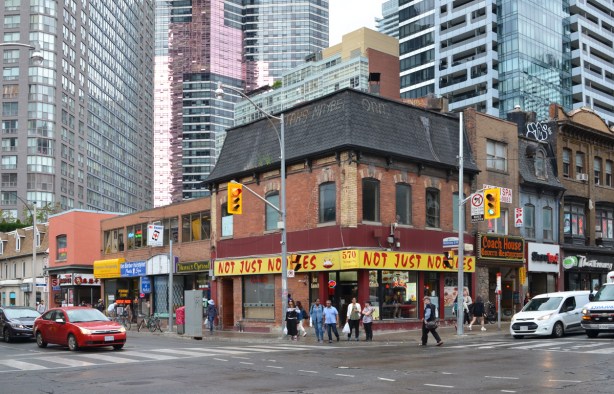 northwest corner of Yonge & wellesley, old brick buildings on Yonge with newer taller condos behind - Not Just noodles restaurant