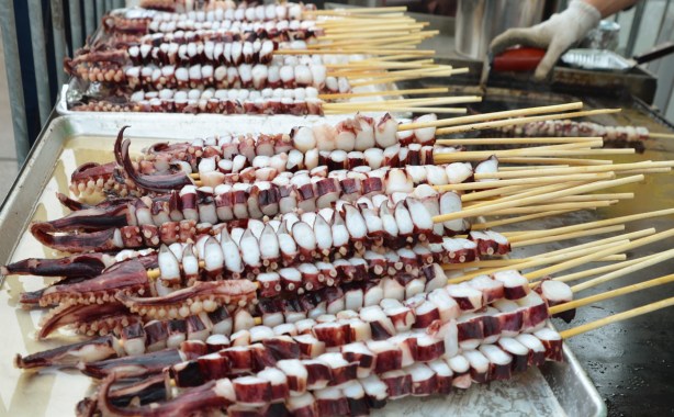 pieces of octopus on skewers, ready to cook