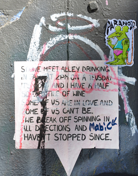 a small sticker with paranoid written on it as well as a graffiti that is all words