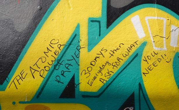 words written in sharpie on green and yellow graffiti 