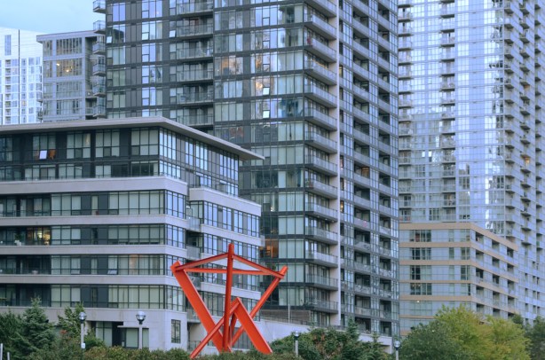 red sculpture in front of condo buildings