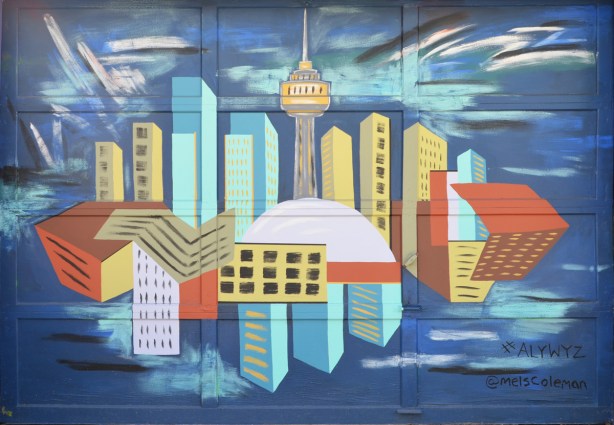 a mural of Toronto skyline reflected in Lake Ontario, stylized, by Mel Coleman in Albert Jackson Lane, painted on a garage door 