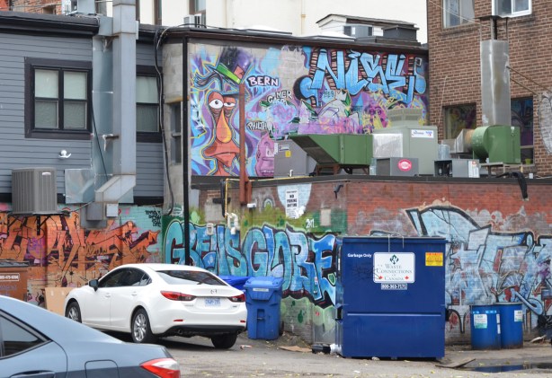walls in alley covered with graffiti