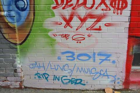 words written under a group of street art pieces, deluxe the 6, names of street artists 