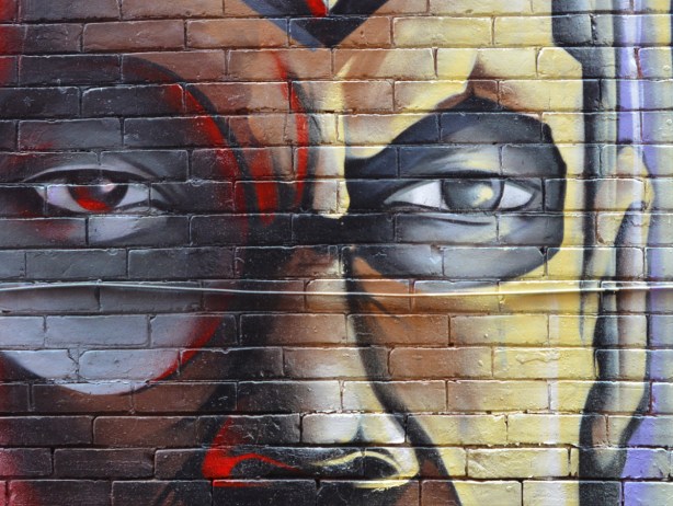 part of mural of man's face, two eyes and a nose, 