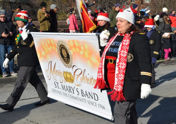 woman holding the end of a banner for St. Marys Band